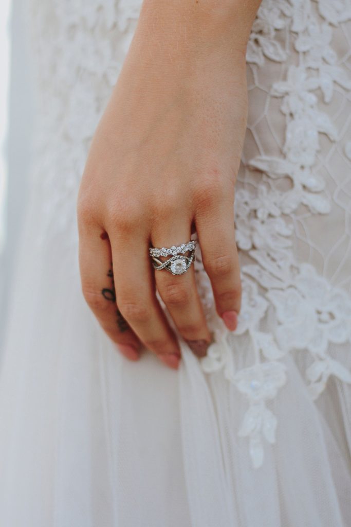 Diamond engagement ring with a matching wedding band in platinum on her hand